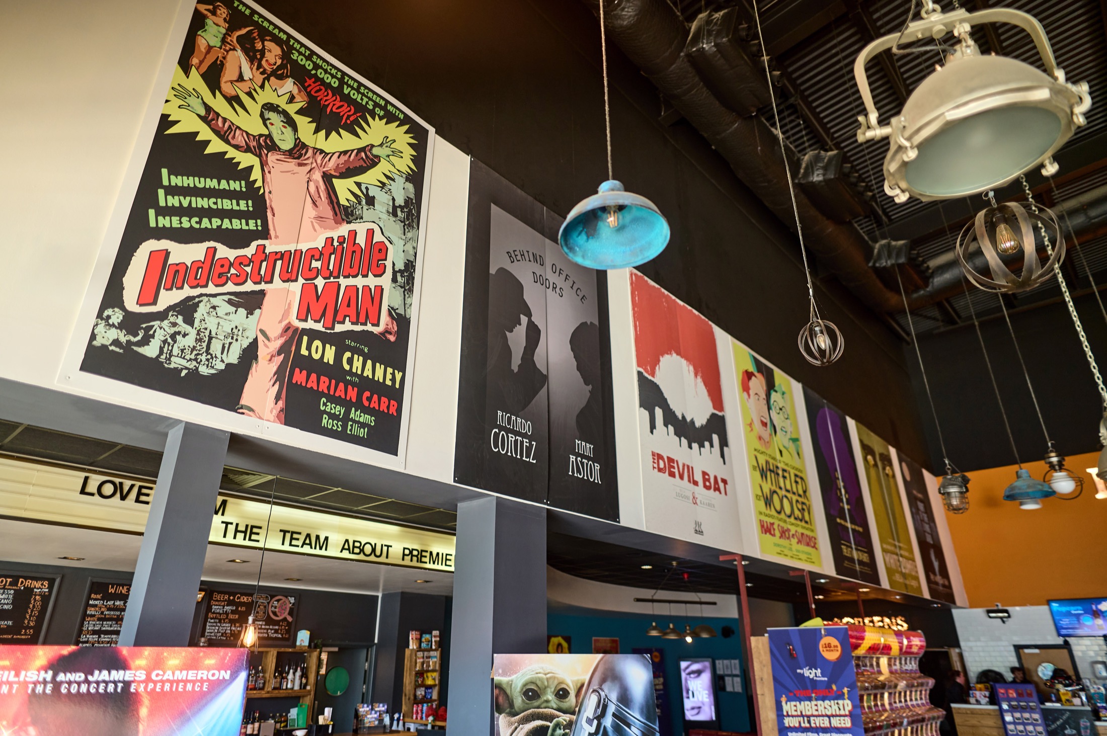 Vintage film posters and hanging lights inside The Light Cambridge cinema